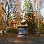 a small wooden building sitting on the side of a road
