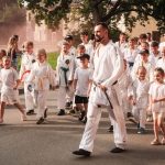 Group of people participating in a martial arts parade outdoors in Limbaži Municipality, Latvia.